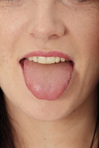 Young cheerful girl showing tongue